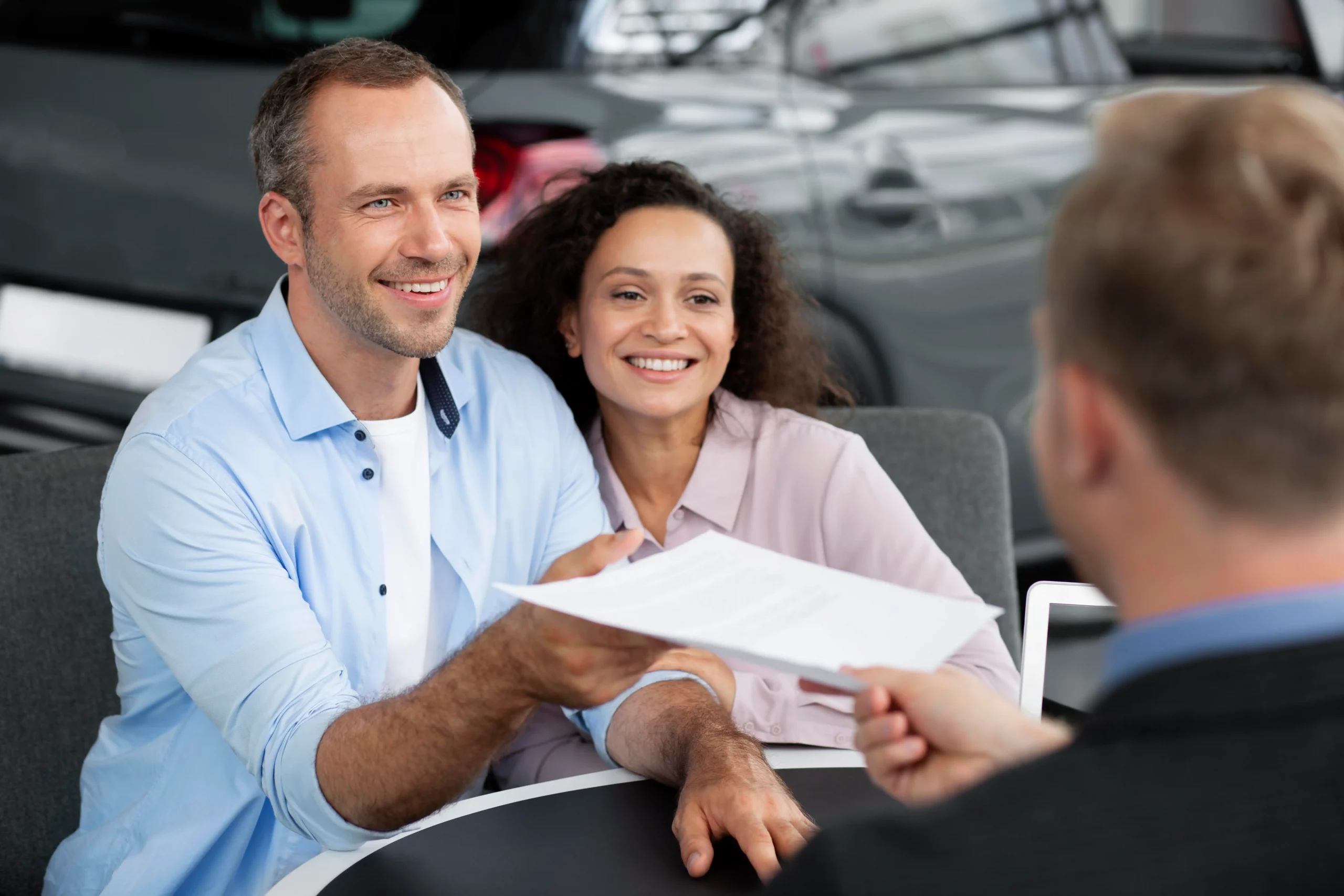 happy-couple-car-showroom-dealership